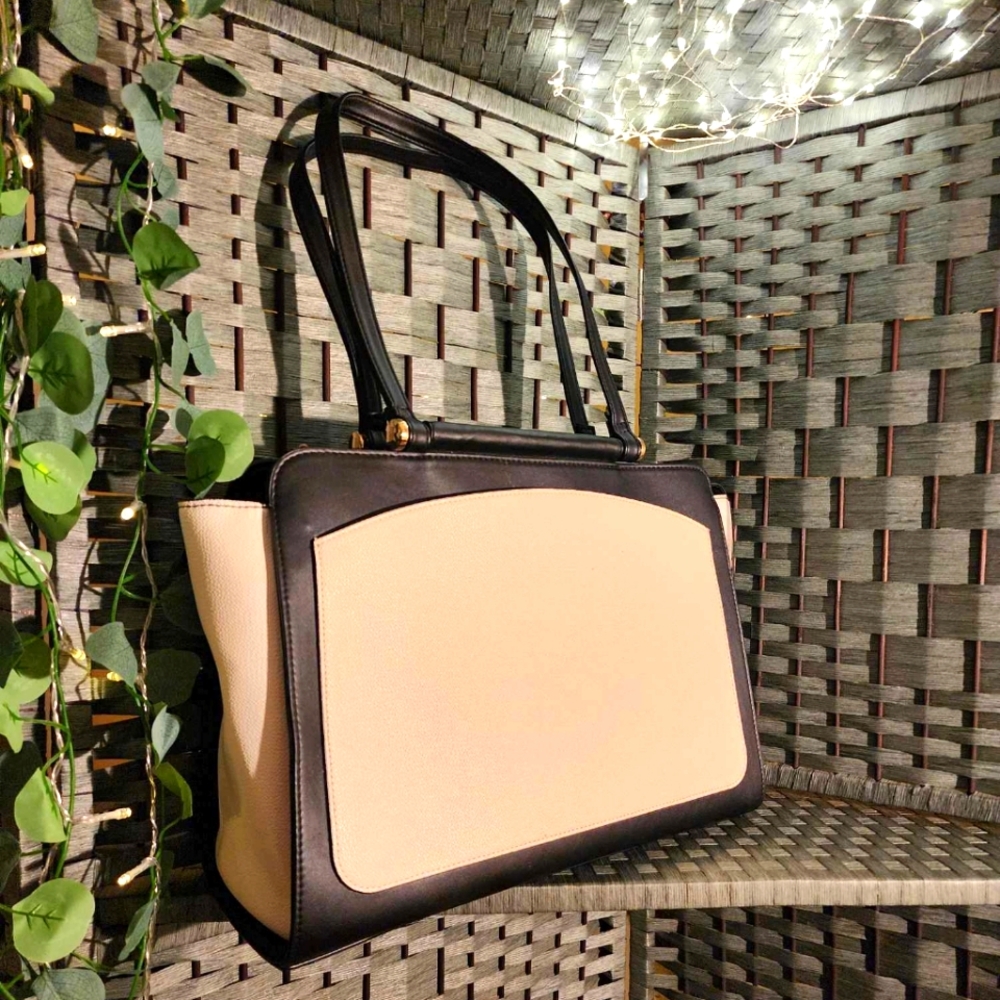 A New Day Breifcase bag, black and white with gold hardware.